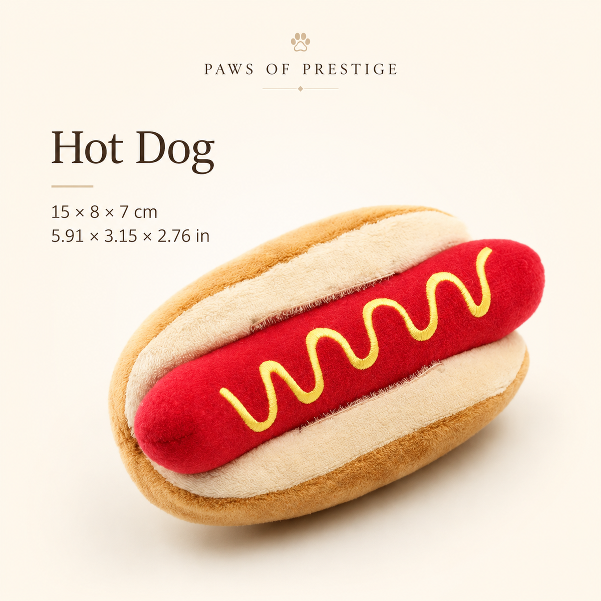 Hot dog shaped plush squeaky dog toy on a clean warm neutral background with size details in centimeters and inches.