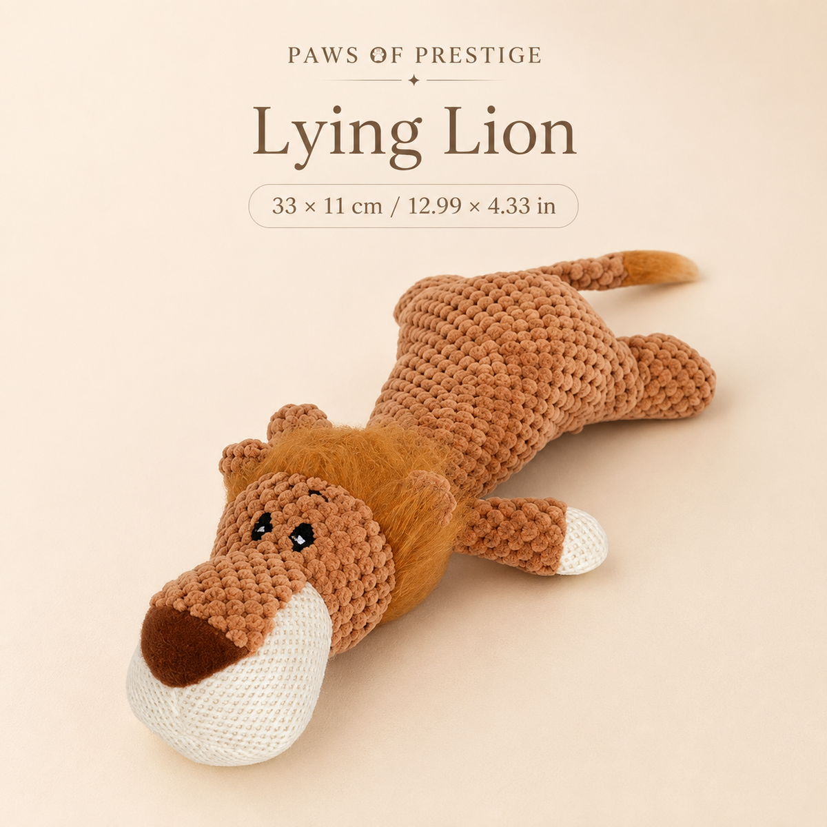 Lying Lion plush squeaky dog toy on a warm neutral background with approximate size shown in centimeters and inches.