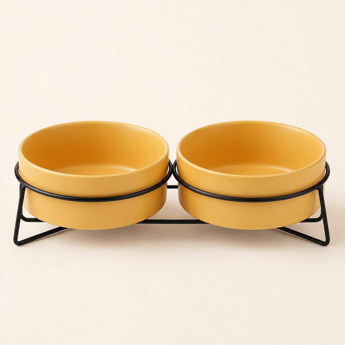 Double elevated yellow ceramic pet bowls in a black metal stand on a soft beige studio background.