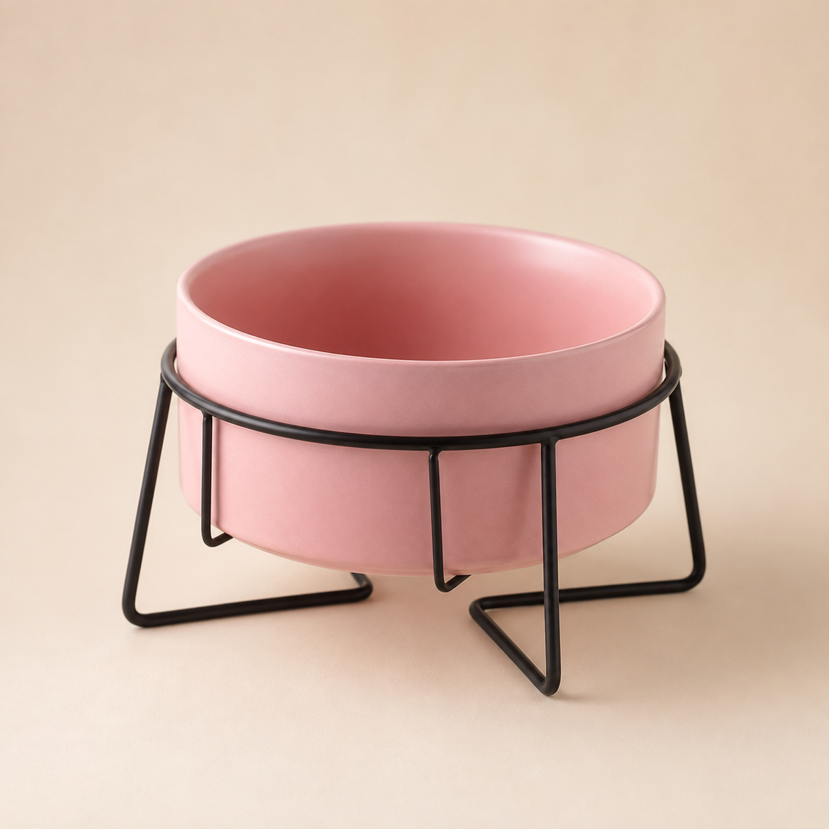 Elevated pink ceramic pet bowl in a black metal stand with a clean premium studio presentation.