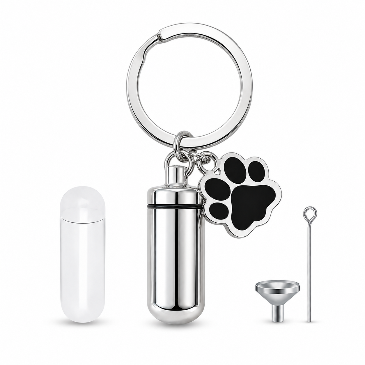 Silver pet memorial keepsake key ring with black paw charm, capsule, funnel and filling pin on white.