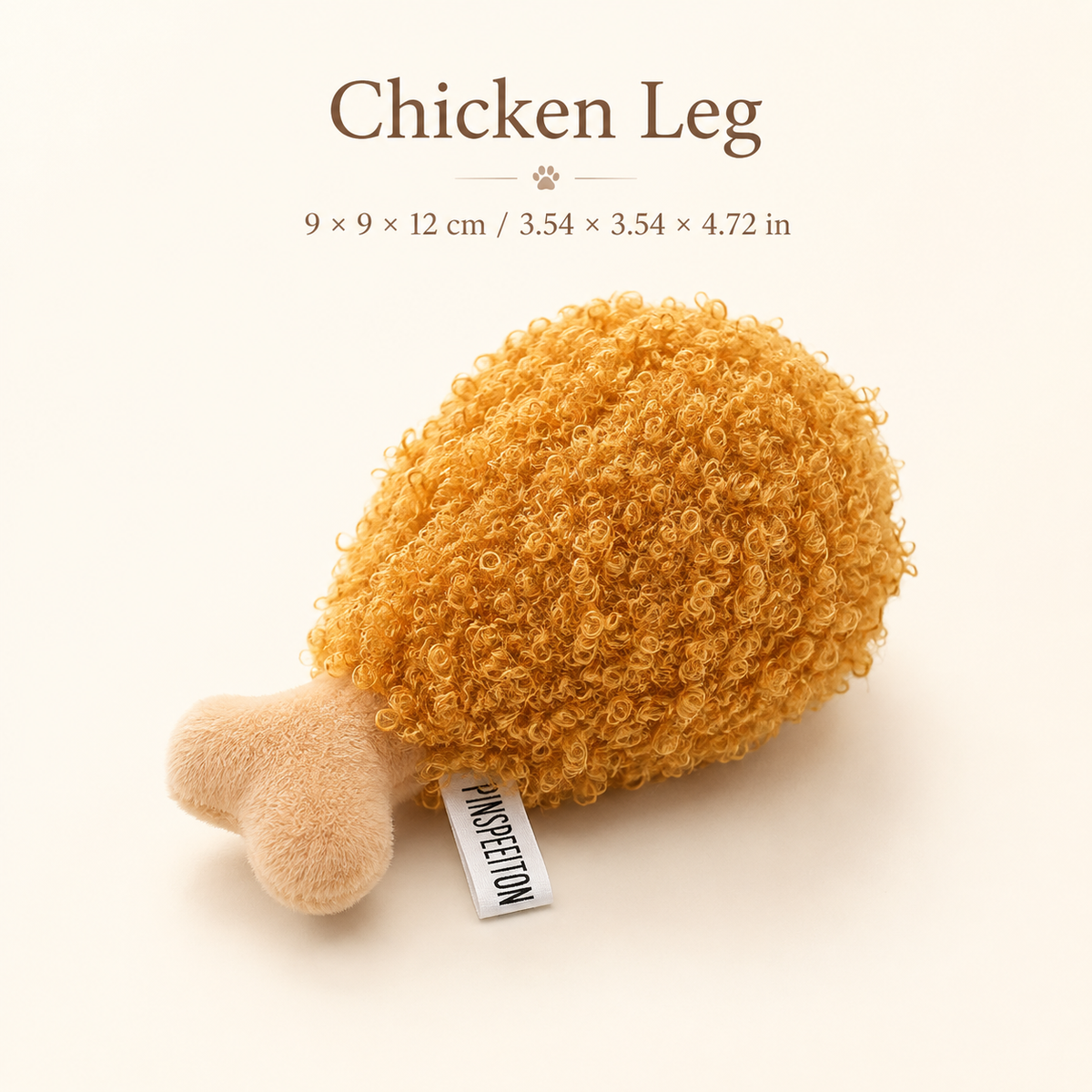 Chicken leg plush squeaky dog toy with textured golden surface shown on an editorial neutral background with dimensions in centimeters and inches.