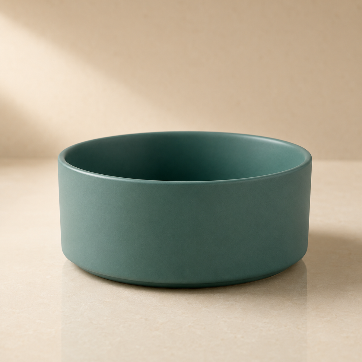 Green ceramic pet bowl without stand photographed in a clean, minimalist studio setting.