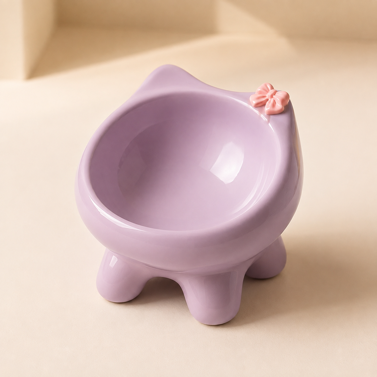 Elevated purple ceramic cat bowl with rounded feet and a pink bow accent on a soft neutral background.