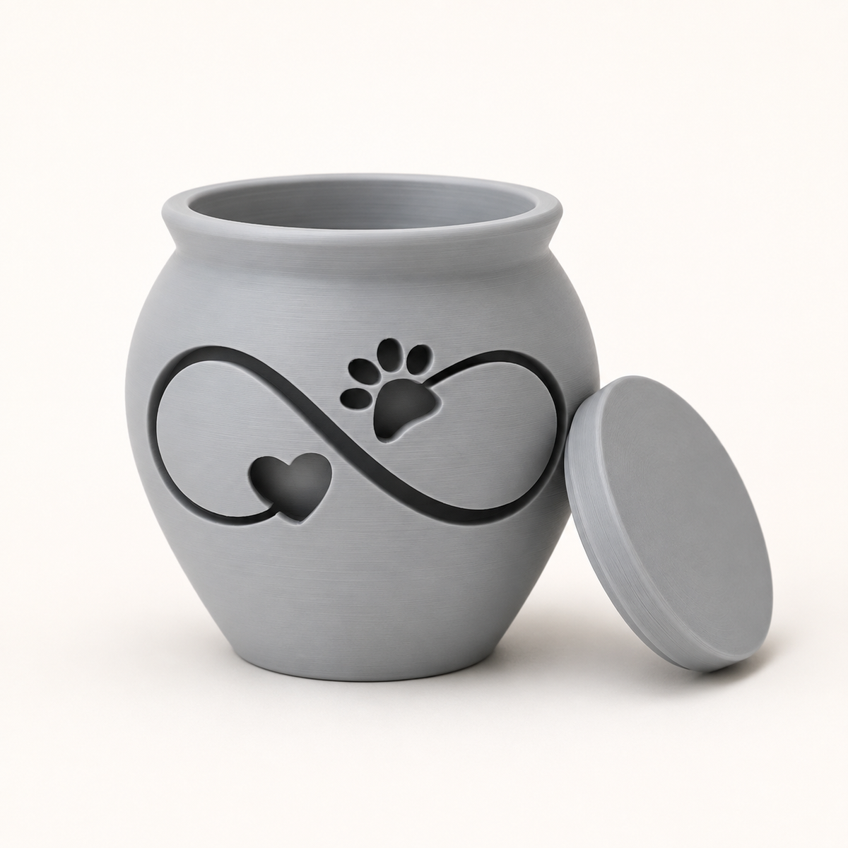 Light gray 3D printed pet memorial urn with infinity symbol, heart, and paw print design, lid removed.