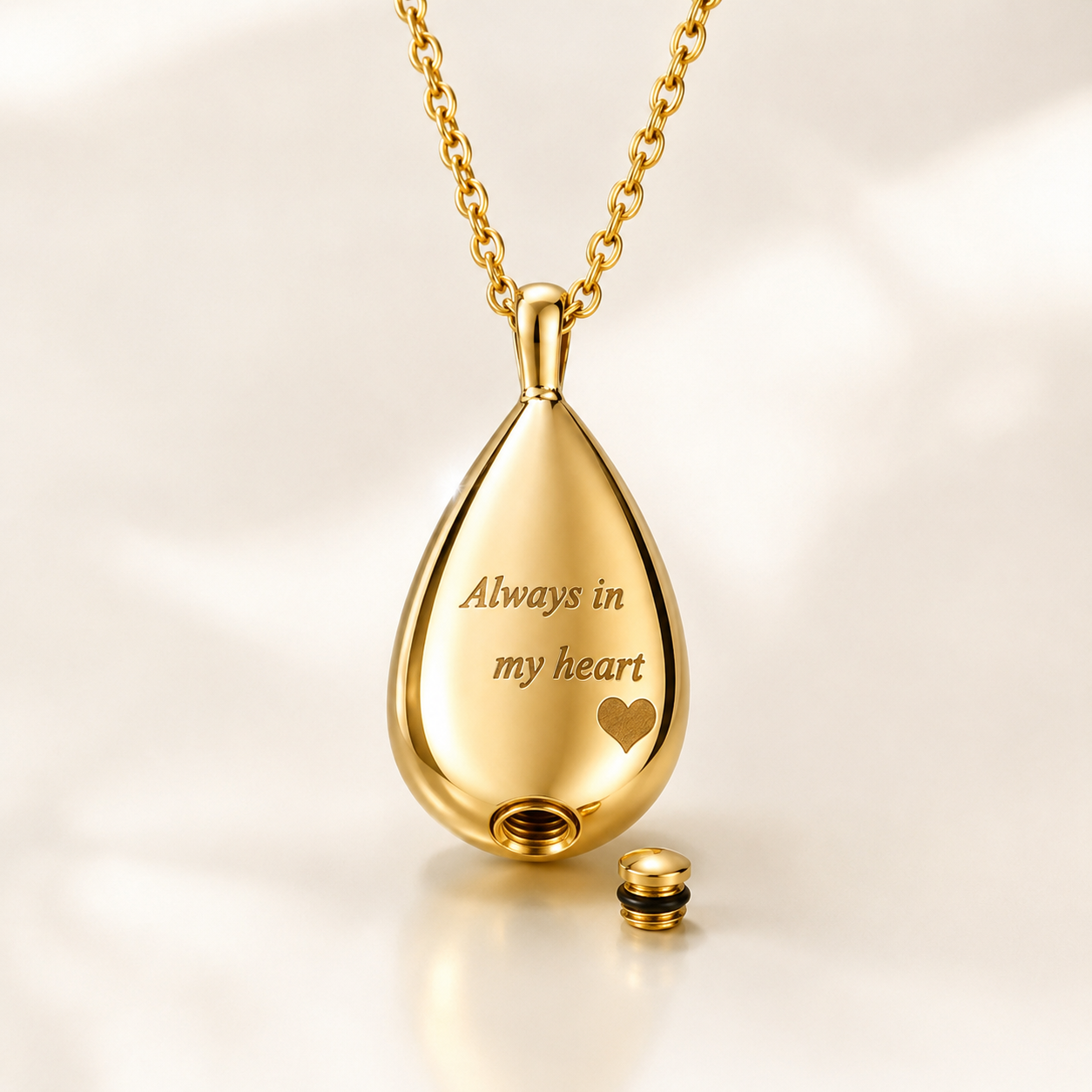 Gold memorial urn pendant necklace engraved “Always in my heart” showing the openable compartment