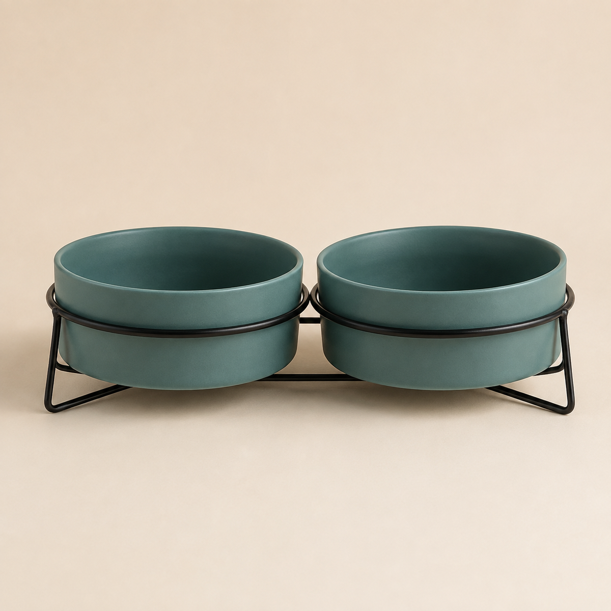 Double elevated green ceramic pet bowls in a black metal stand on a warm neutral background.