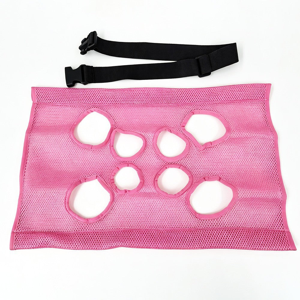 Pink mesh grooming sling laid flat, showing all eight openings, with the black adjustable strap above it. No frame is shown.