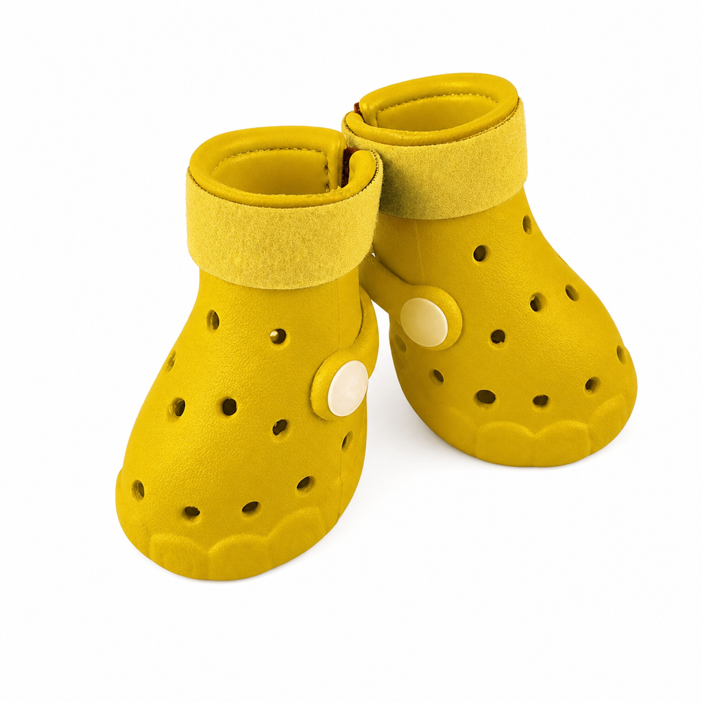 Two yellow EVA dog boots with matching straps and cream side studs.