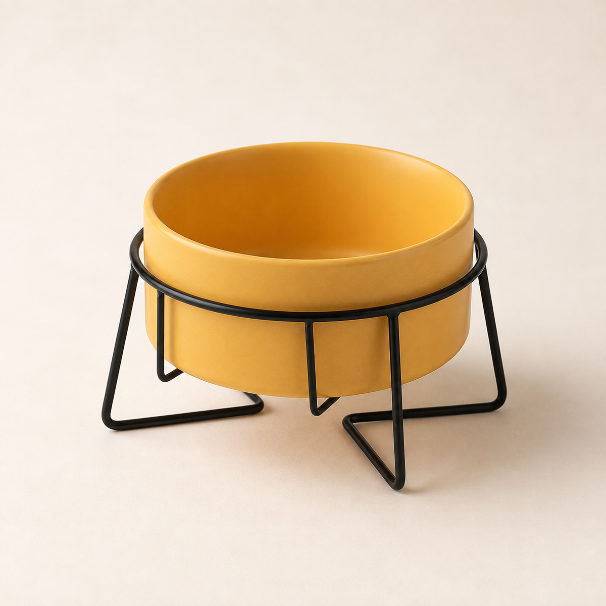 Elevated yellow ceramic pet bowl in a black metal stand on a warm neutral studio background.