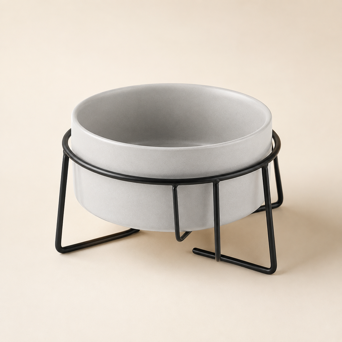 Elevated gray ceramic pet bowl in a black stand with a warm, premium ecommerce look.