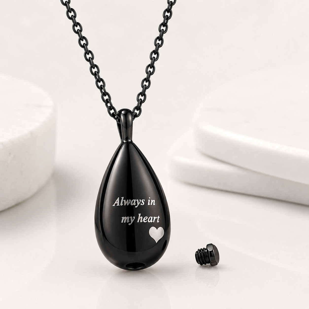 Black memorial urn pendant necklace engraved “Always in my heart” showing the openable compartment