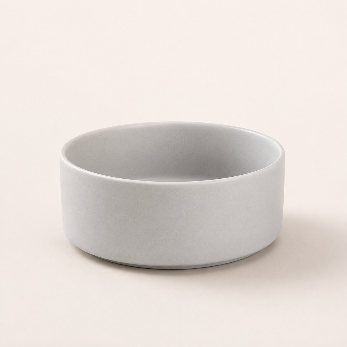 Gray ceramic pet bowl without stand displayed on a soft neutral background.