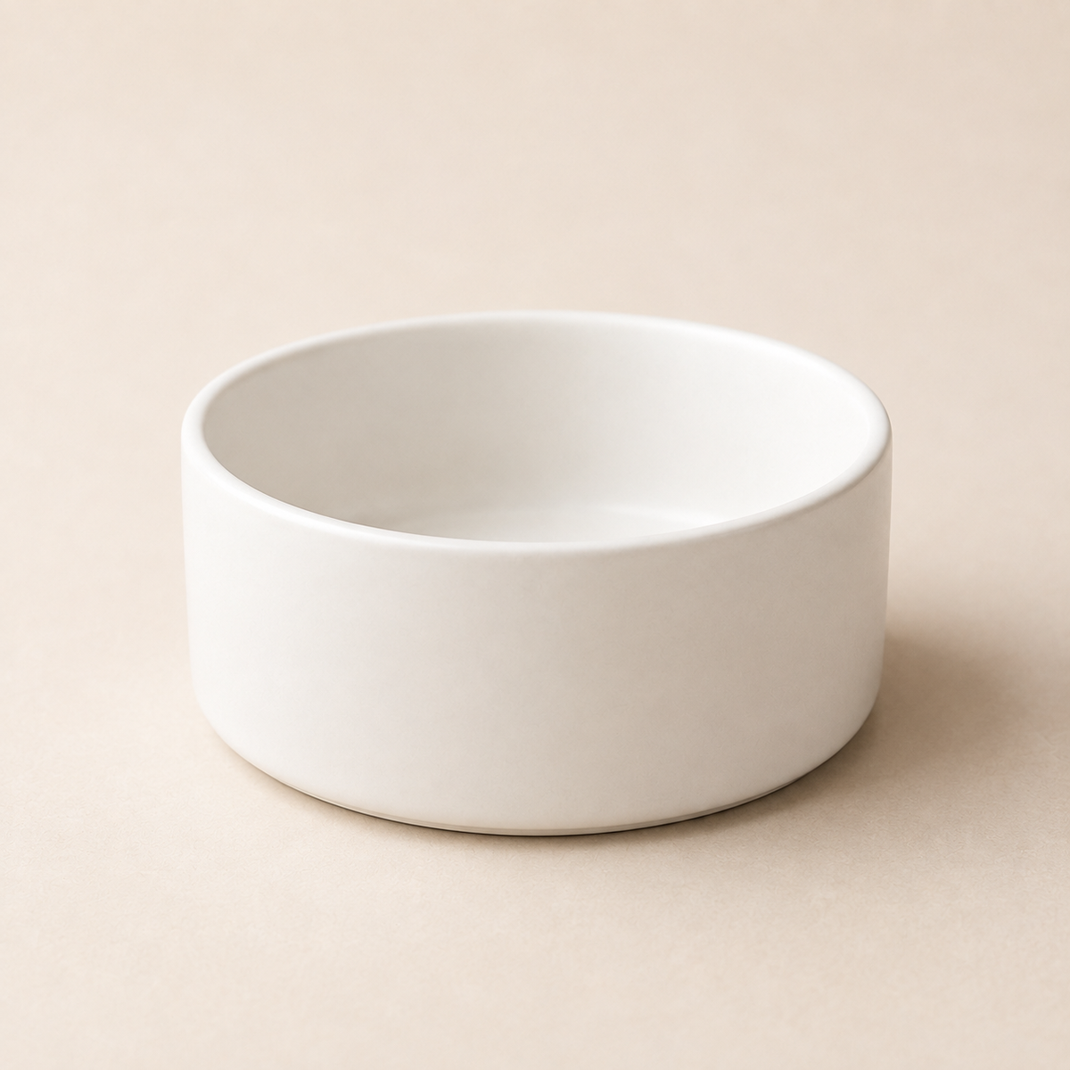 White ceramic pet bowl without stand in a clean, modern studio scene.