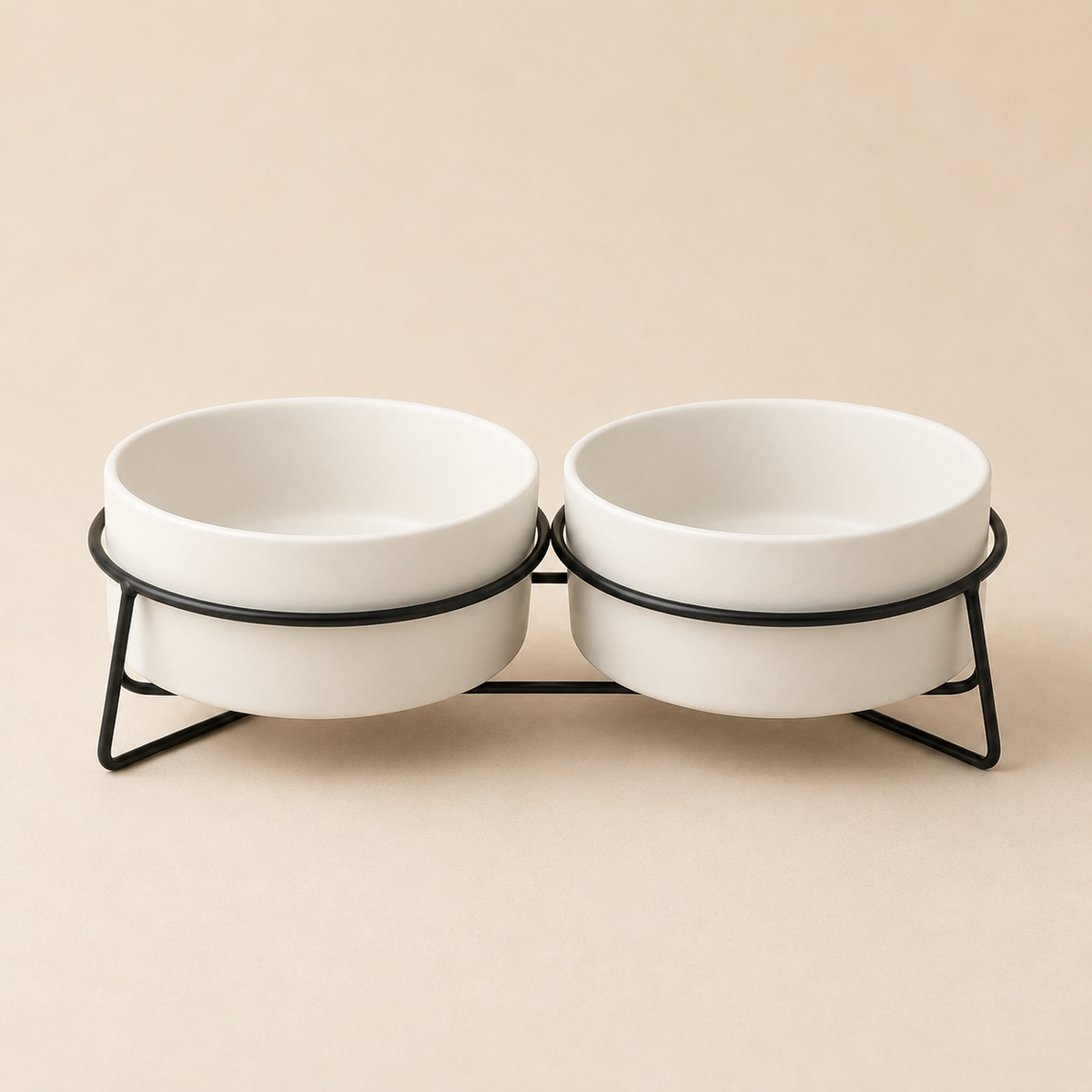 Double elevated white ceramic pet bowls in a black metal stand photographed for premium ecommerce.